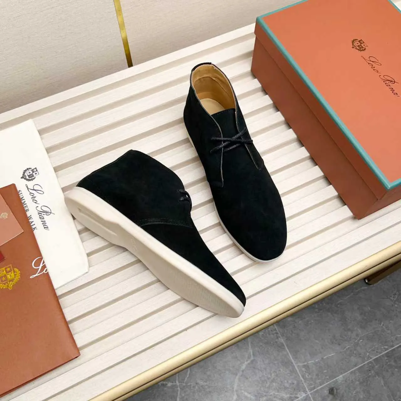Men's Shoes 💰420 Loro Piana reimagines the desert boot—a modern, comfortable interpretation of a classic 1940s style. Crafted from suede calfskin, it exudes elegance. The tight texture of suede calfskin is not only durable but also looks casual and sophisticated. Add a timeless piece to your shoe collection, harmoniously blending comfort, style and Loro Piana's heritage of craftsmanship. Acetate satin detail on the inside White sole with LP lettering for added traction Space for a personalized signature on the heel Tonal suede trim Upper: 100% cow split suede Sole: 100% Rubber lining: Cow leather